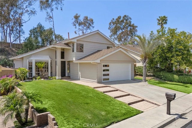 view of front of property featuring an attached garage, a front yard, and concrete driveway