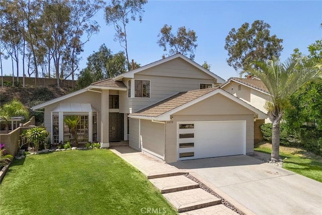 view of front facade with driveway, a front lawn, and a garage