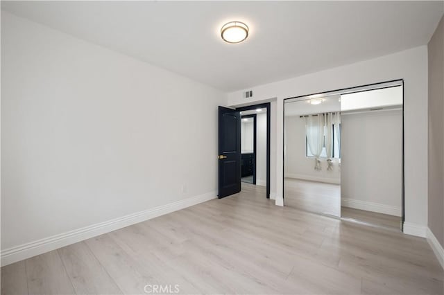 8535 Village Ln, Rosemead, CA 91770 - unfurnished bedroom featuring a closet, baseboards, visible vents, and light wood-style floors