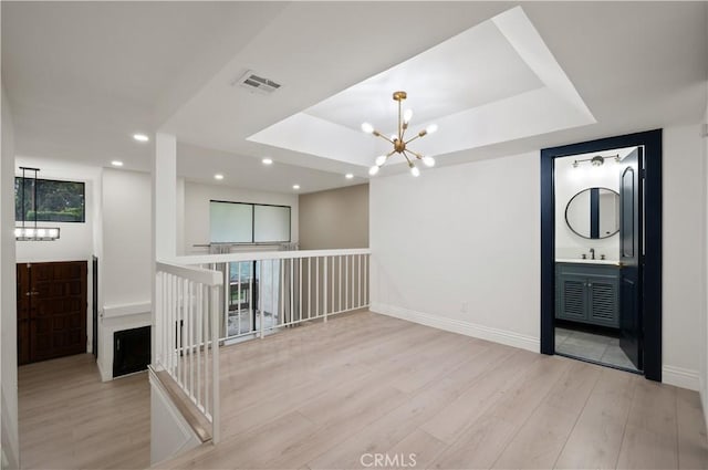 8535 Village Ln, Rosemead, CA 91770 - empty room with visible vents, a notable chandelier, wood finished floors, and a tray ceiling