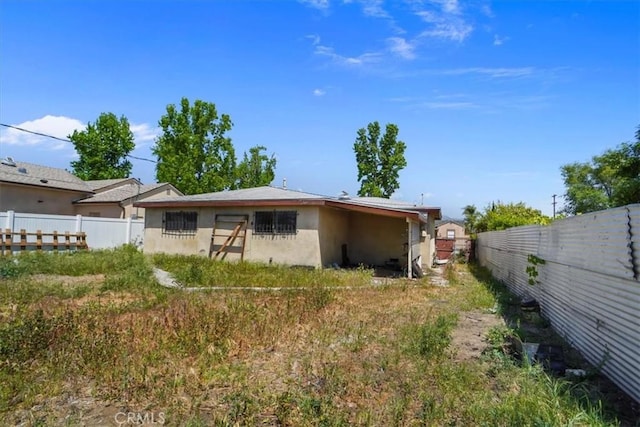 7941 Rhodes Ave, North Hollywood, CA 91605 - rear view of house featuring fence and stucco siding