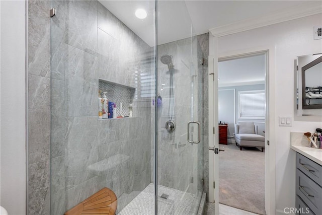 ensuite bathroom featuring visible vents, ornamental molding, vanity, ensuite bathroom, and a stall shower
