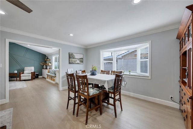 dining room featuring crown molding, baseboards, and light wood-type flooring