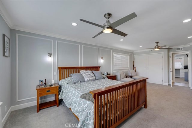 bedroom with crown molding, visible vents, a decorative wall, recessed lighting, and carpet