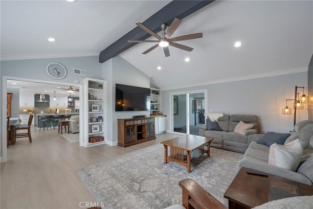 living area with ceiling fan, built in shelves, light wood-style flooring, vaulted ceiling with beams, and visible vents