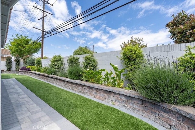 surrounding community with a fenced backyard and a lawn
