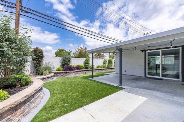 view of yard with fence and a patio area