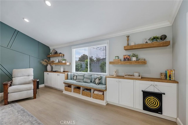 sitting room with recessed lighting, ornamental molding, and light wood-style flooring