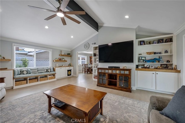 living room with a ceiling fan, lofted ceiling with beams, ornamental molding, and a healthy amount of sunlight