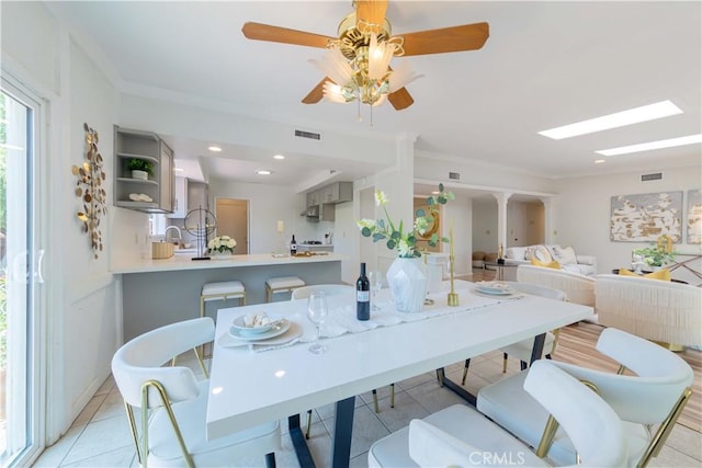 dining room with visible vents, a ceiling fan, and light tile patterned floors