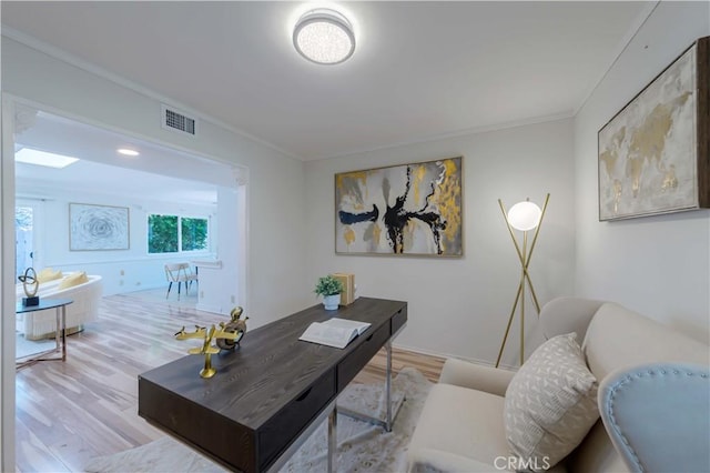 living area featuring ornamental molding, wood finished floors, and visible vents