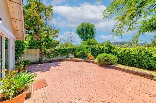 view of patio featuring fence