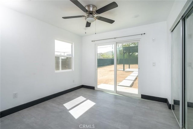 interior space featuring access to outside, baseboards, a ceiling fan, and a closet