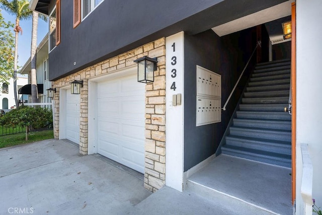 garage featuring concrete driveway