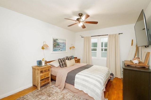 bedroom with baseboards, light wood-style flooring, and ceiling fan