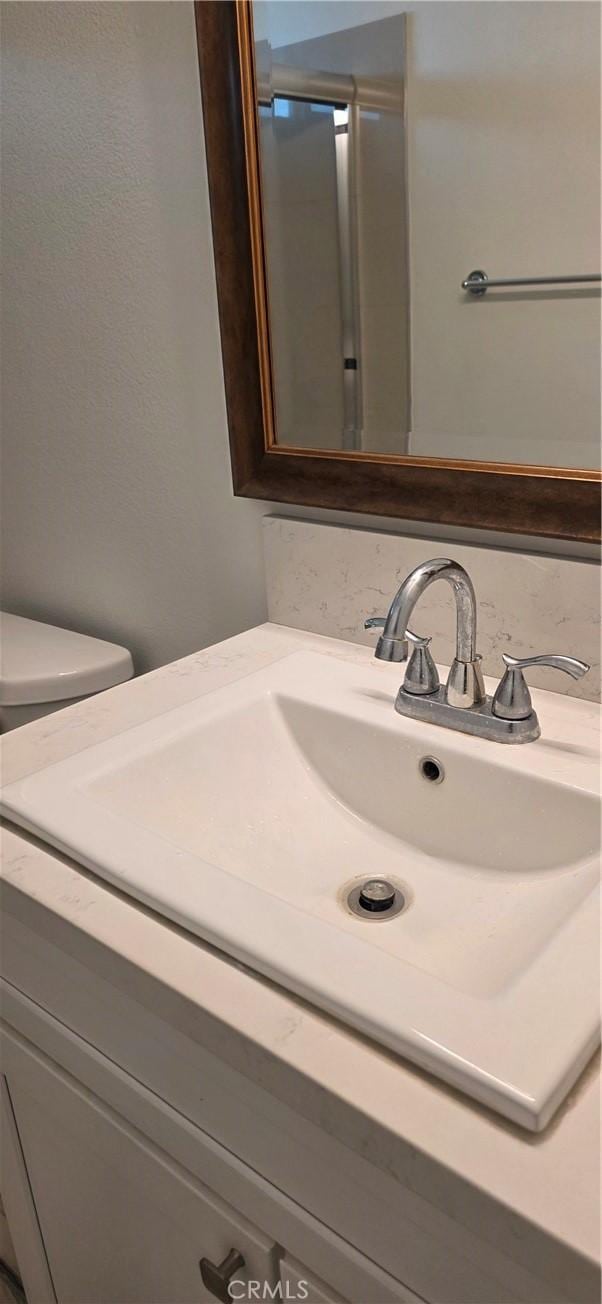 bathroom with vanity and toilet