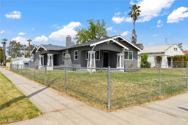 bungalow-style home with a front yard, stucco siding, a chimney, a porch, and a fenced front yard