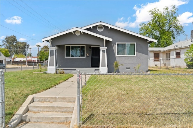 bungalow featuring a front lawn, stucco siding, and fence