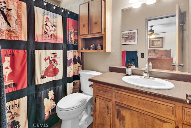 4957 Buck Tail Ln, Paso Robles, CA 93446 - bathroom with toilet, vanity, ceiling fan, a shower with shower curtain, and a textured wall