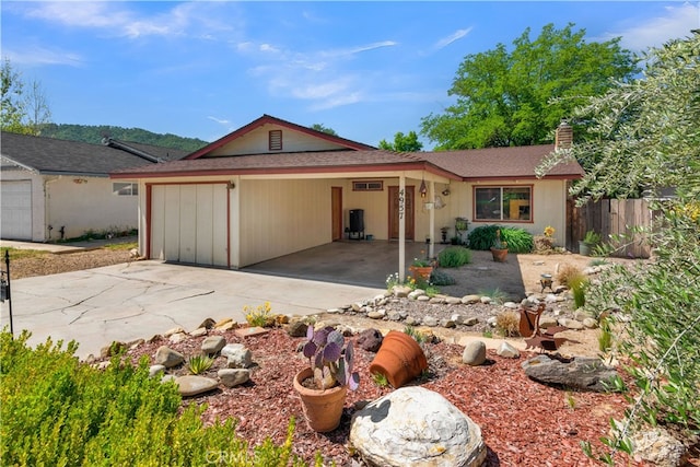 4957 Buck Tail Ln, Paso Robles, CA 93446 - ranch-style house featuring concrete driveway, a chimney, and a garage