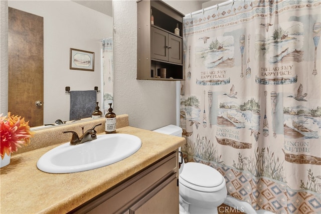 4957 Buck Tail Ln, Paso Robles, CA 93446 - bathroom featuring toilet, vanity, a shower with shower curtain, and a textured wall