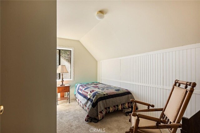 bedroom with carpet flooring and lofted ceiling