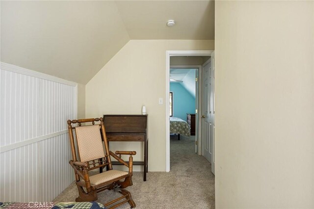 sitting room featuring light colored carpet and vaulted ceiling