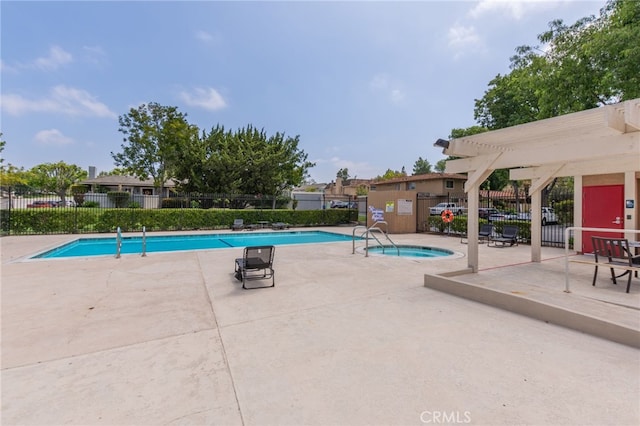 pool featuring a pergola, fence, and a patio area