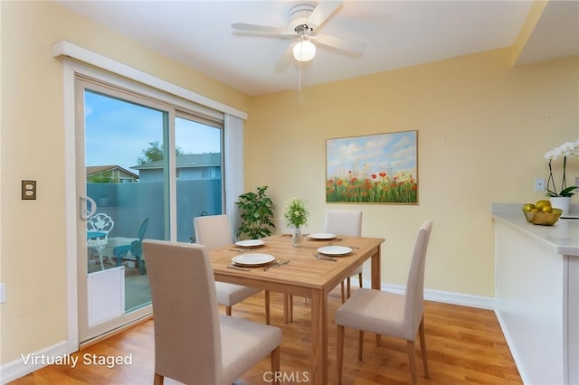 dining area with ceiling fan, baseboards, and light wood-type flooring