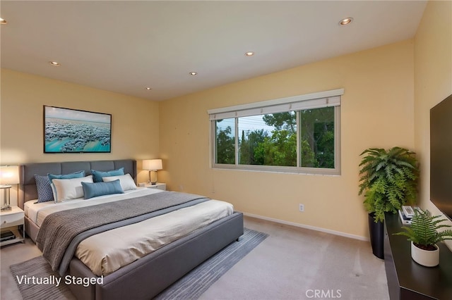 bedroom with baseboards, recessed lighting, and light carpet