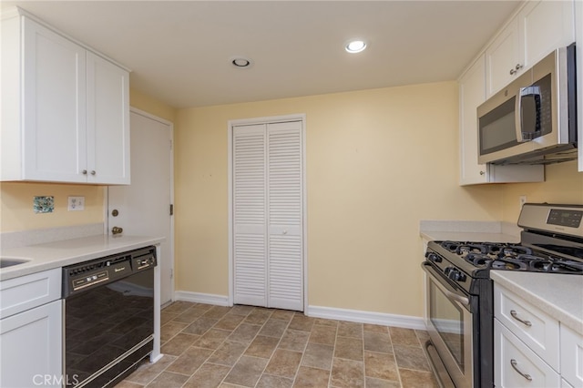 kitchen with white cabinets, recessed lighting, baseboards, and appliances with stainless steel finishes