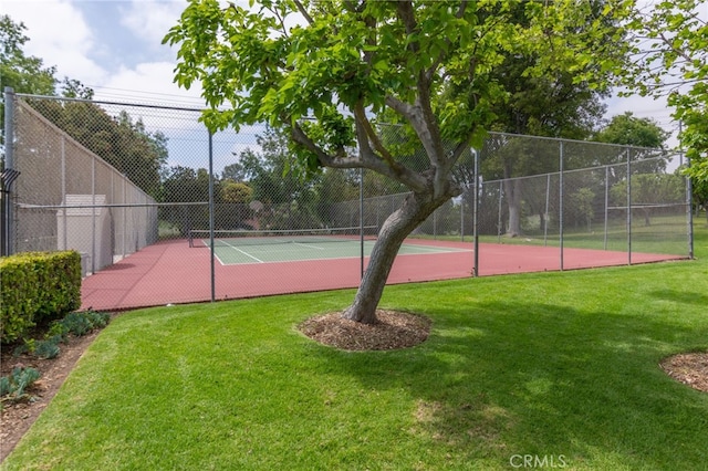 view of sport court featuring a lawn and fence