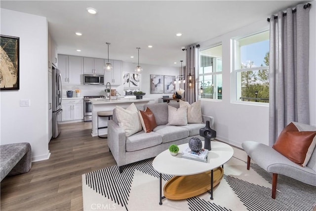 960 N Tangent Privado Unit 204, Ontario, CA 91764 - living area with baseboards, recessed lighting, and wood finished floors