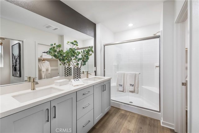 960 N Tangent Privado Unit 204, Ontario, CA 91764 - full bathroom with visible vents, a sink, wood finished floors, and a shower stall