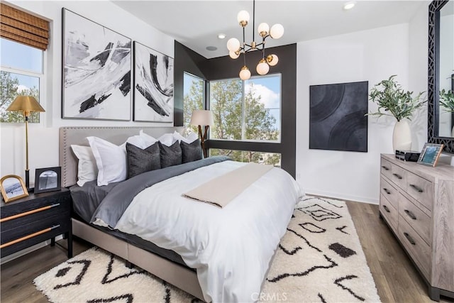960 N Tangent Privado Unit 204, Ontario, CA 91764 - bedroom featuring an inviting chandelier, recessed lighting, baseboards, and wood finished floors