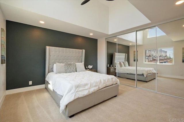 carpeted bedroom featuring recessed lighting, baseboards, and a closet