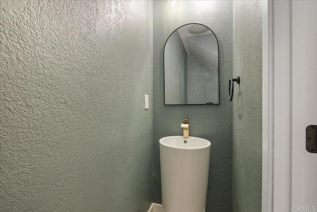 bathroom with a textured wall
