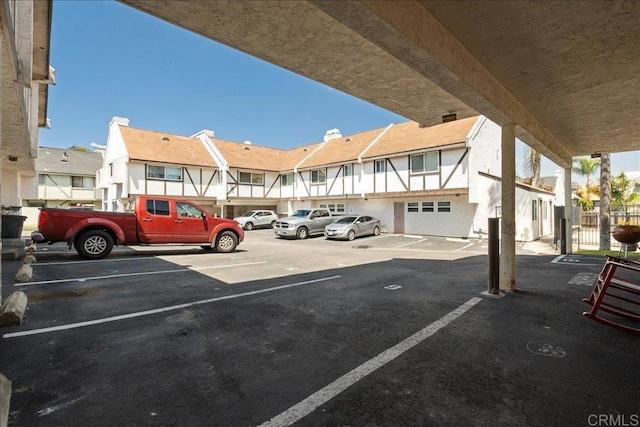 uncovered parking lot featuring a residential view