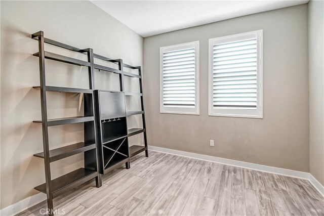 unfurnished bedroom featuring baseboards and wood finished floors