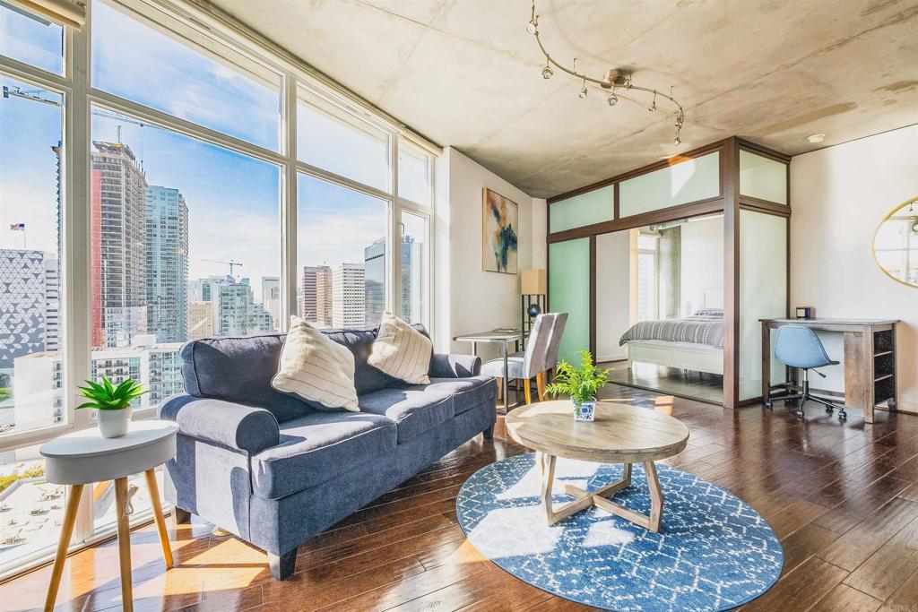 living area featuring plenty of natural light, a city view, and hardwood / wood-style flooring