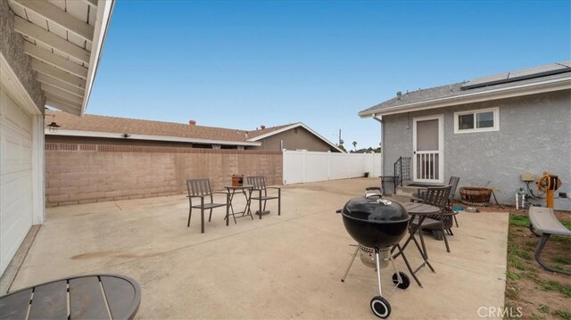 view of patio / terrace featuring area for grilling, outdoor dining area, a fenced backyard, and entry steps