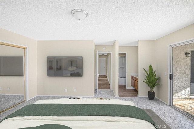 bedroom with carpet floors, a textured ceiling, and baseboards
