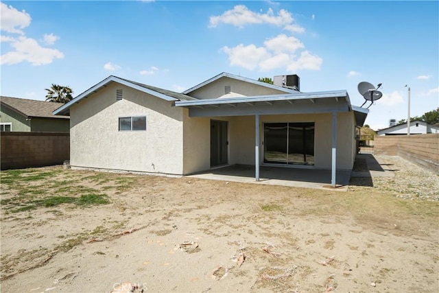 back of house featuring a fenced backyard, stucco siding, and a patio area