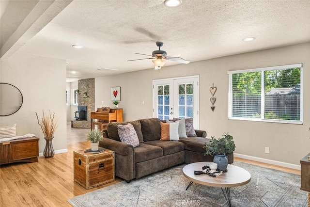 living room with ceiling fan, french doors, baseboards, light wood-style floors, and recessed lighting