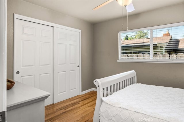 bedroom with a ceiling fan, a closet, and light wood-type flooring