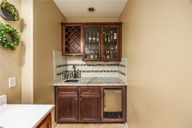 bar with indoor wet bar, backsplash, a sink, and wine cooler