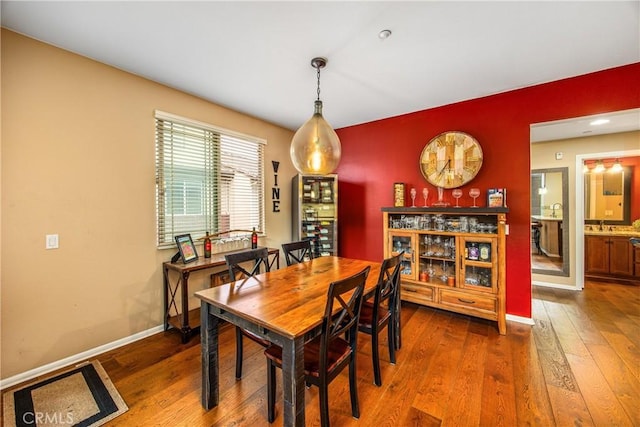 dining area with baseboards and wood-type flooring