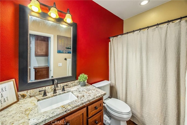full bathroom featuring vanity and toilet