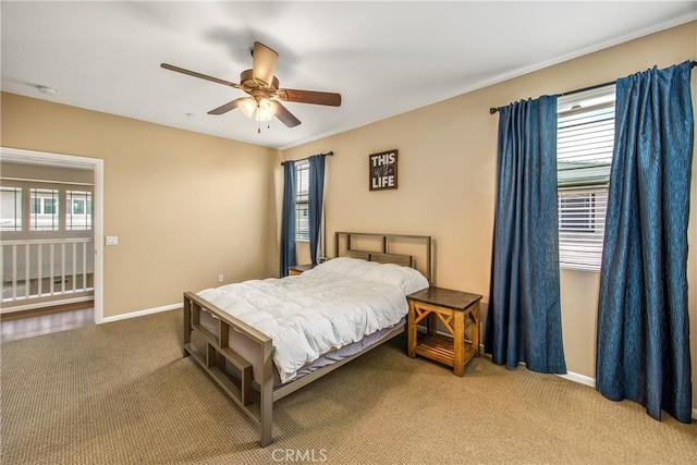 bedroom with carpet flooring, a ceiling fan, baseboards, and multiple windows