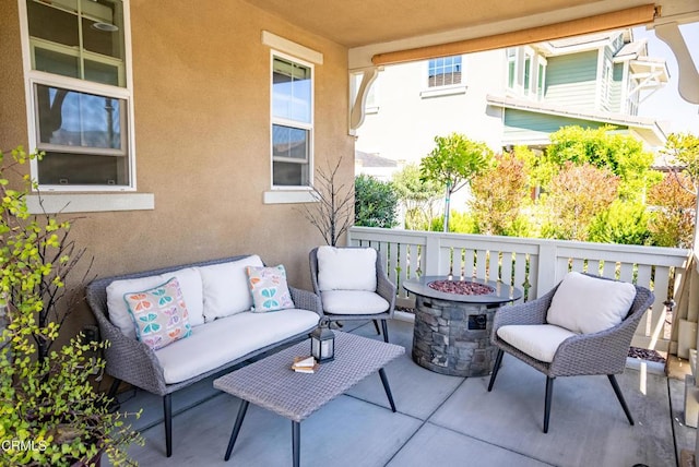 view of patio featuring an outdoor living space with a fire pit
